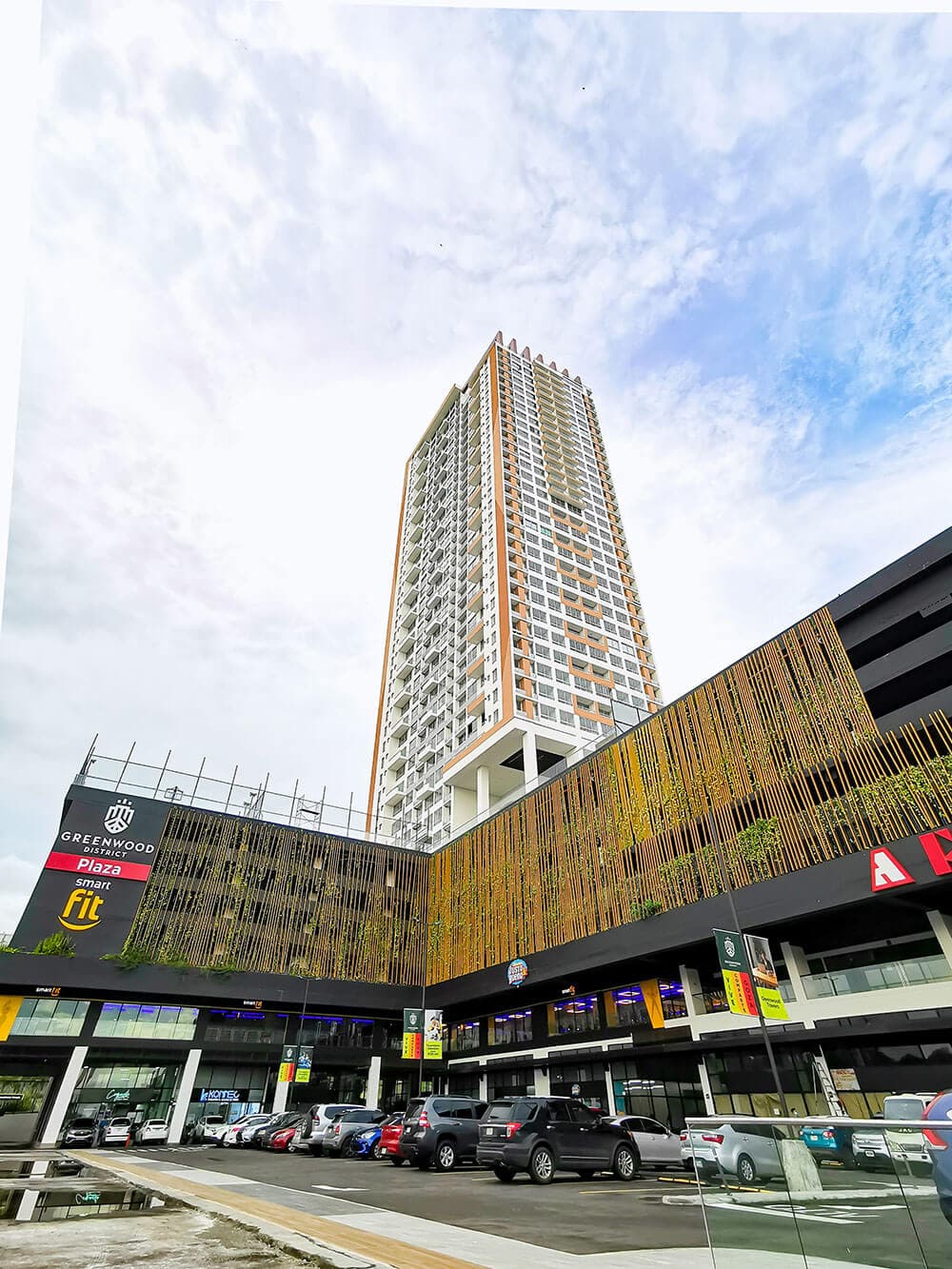 Greenwood Plaza commercial building with wood-slat facade below Greenwood Towers