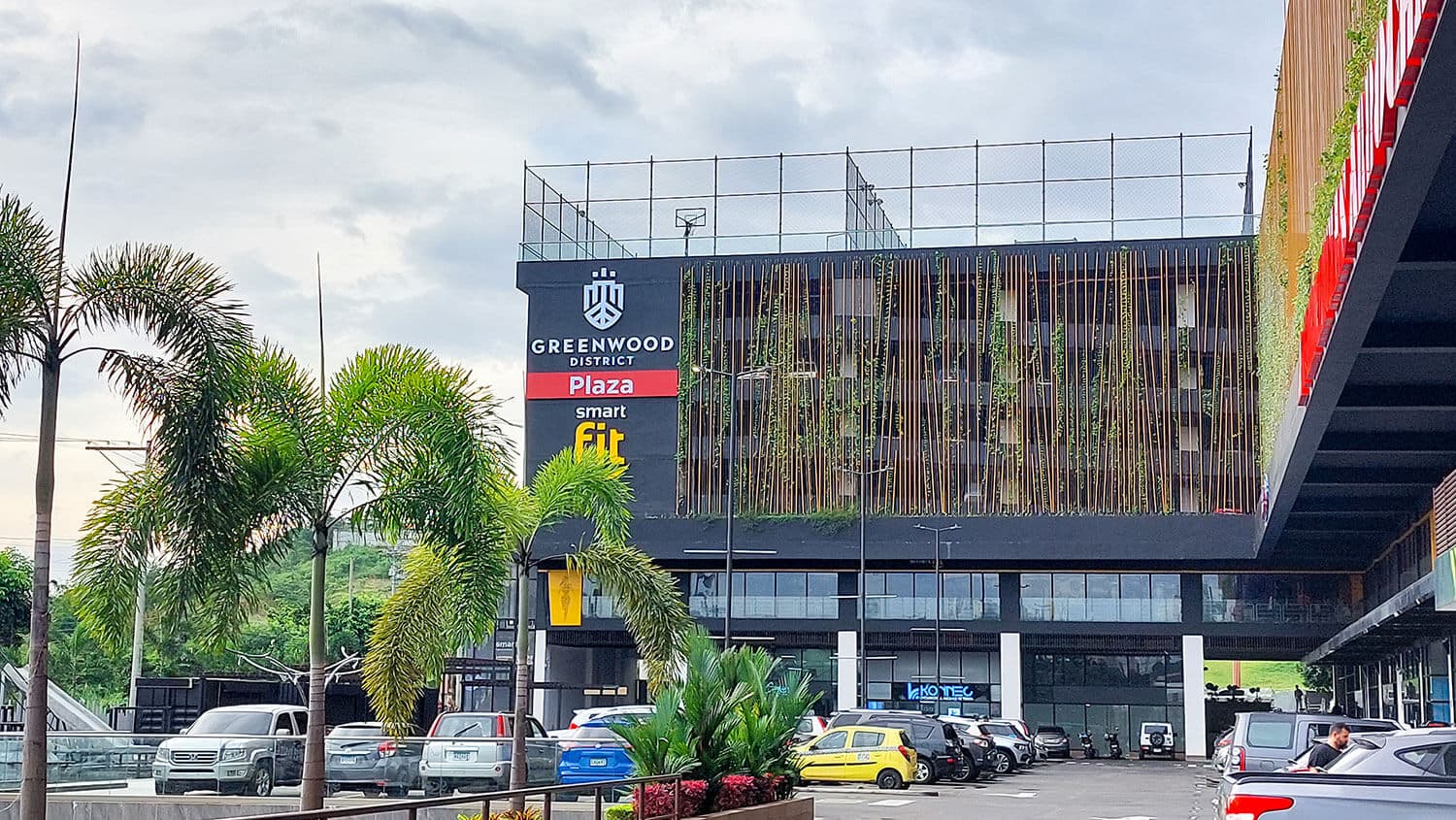 Greenwood Plaza upper-level commercial facade with palm trees