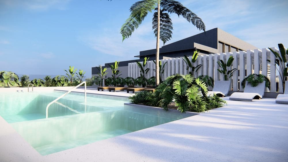 Pool deck with loungers and palms at Armonía
