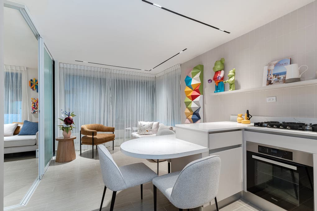 Open kitchen and dining area in an Armonía model apartment