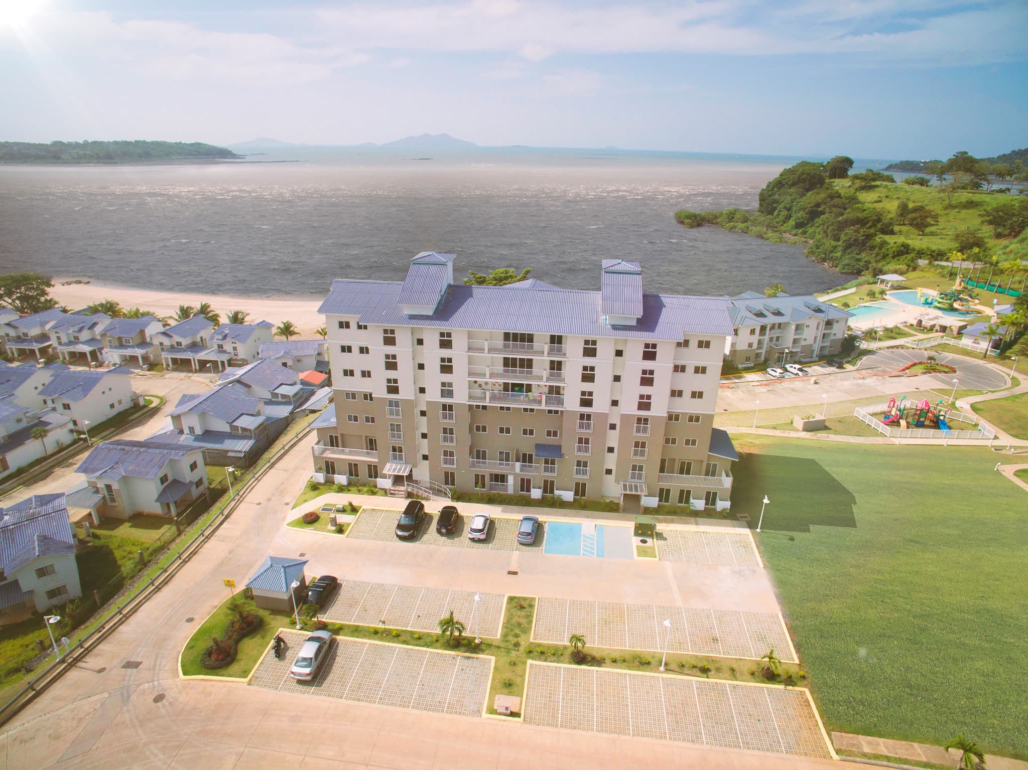Aerial view of the Altamarina apartment building at Playa Dorada with the Pacific Ocean behind