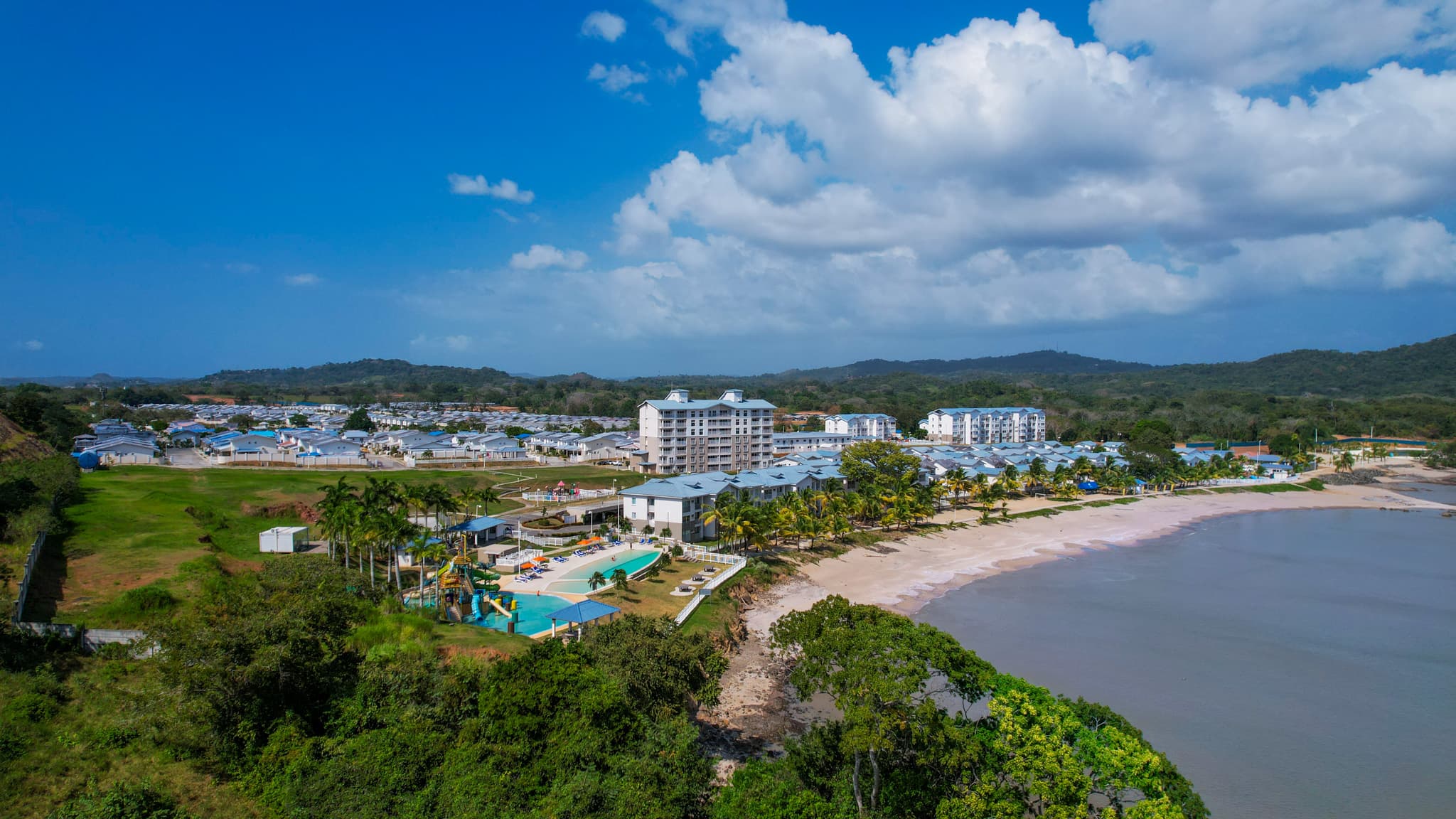 Wide aerial of Playa Dorada residences, pools and beach in Panama Oeste