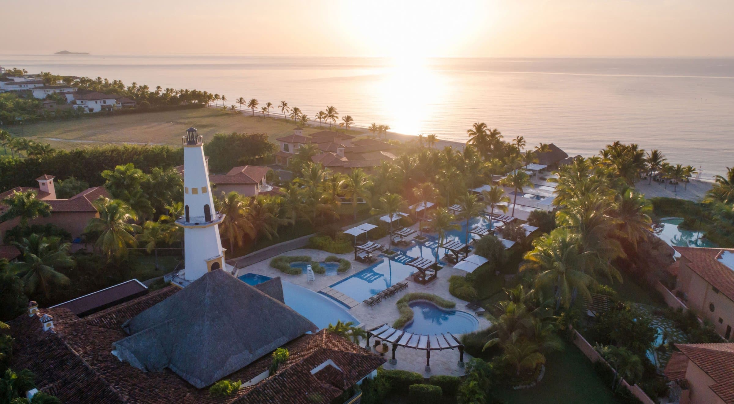 Sunset aerial view of the Buenaventura resort hotel and gardens by the ocean