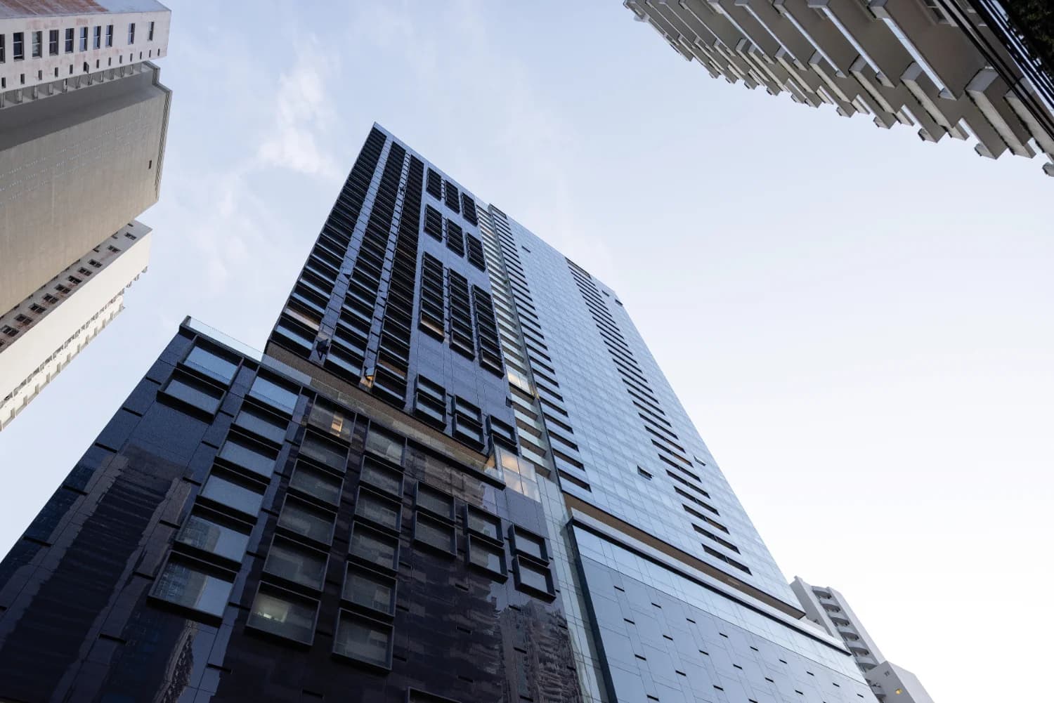 Nuovo by Armani/Casa tower facade looking up at the dark glass and framed windows