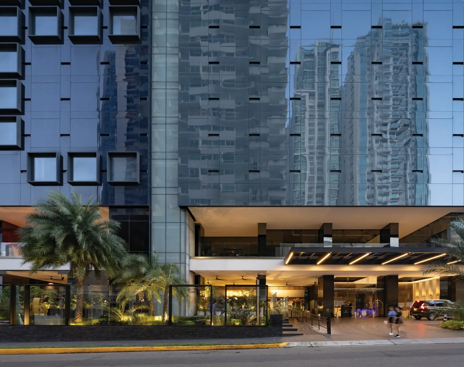 Nuovo by Armani/Casa building entrance and landscaped podium at dusk
