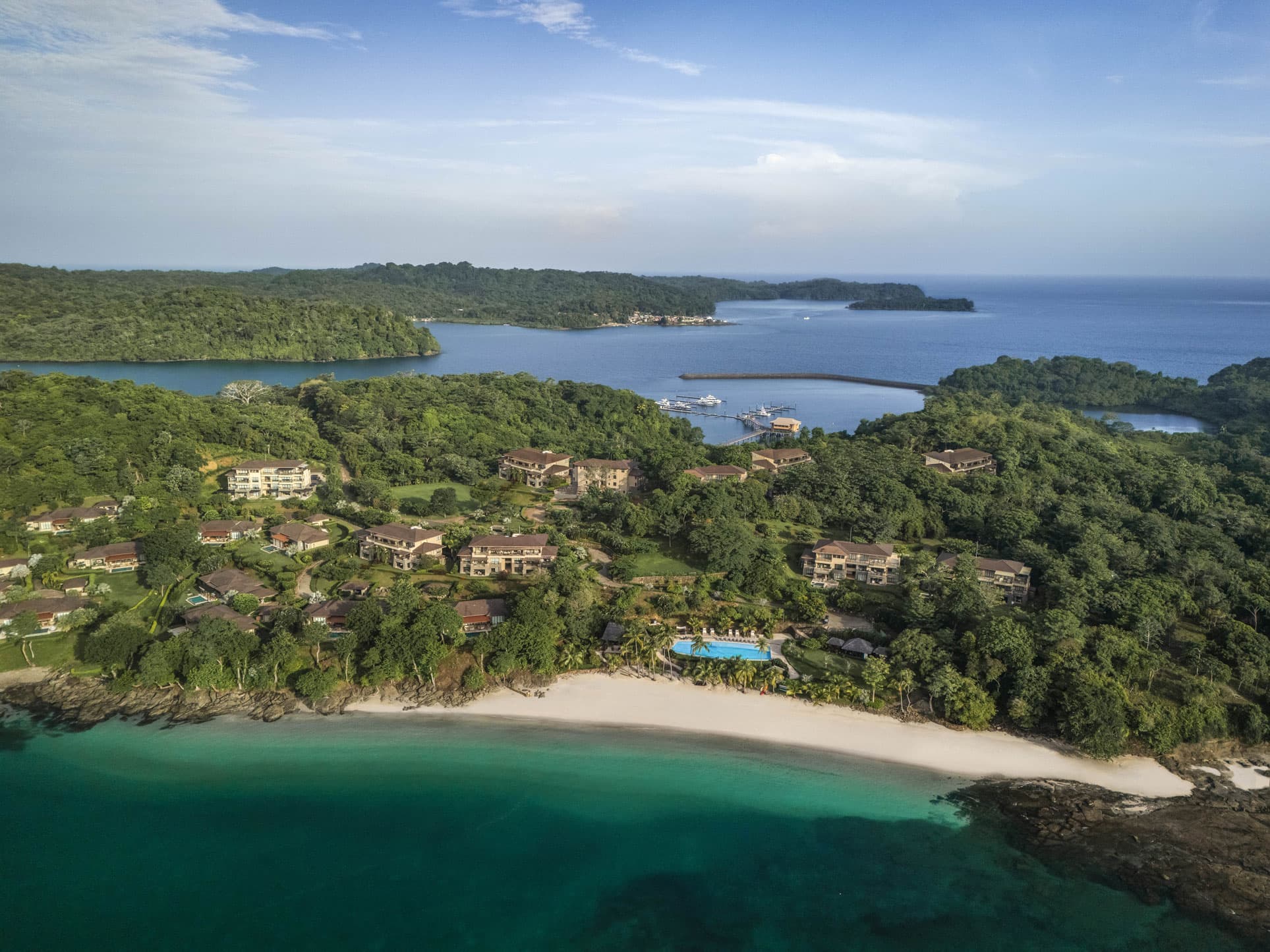 Aerial view of La Peninsula on Pearl Island with residences above the beach and Beach Club pool