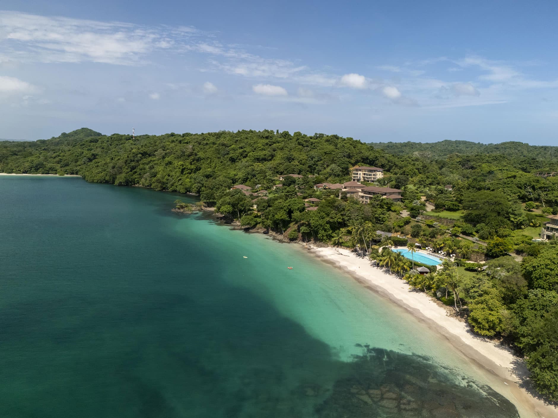 Aerial view of the white-sand beach and turquoise water along Pearl Island