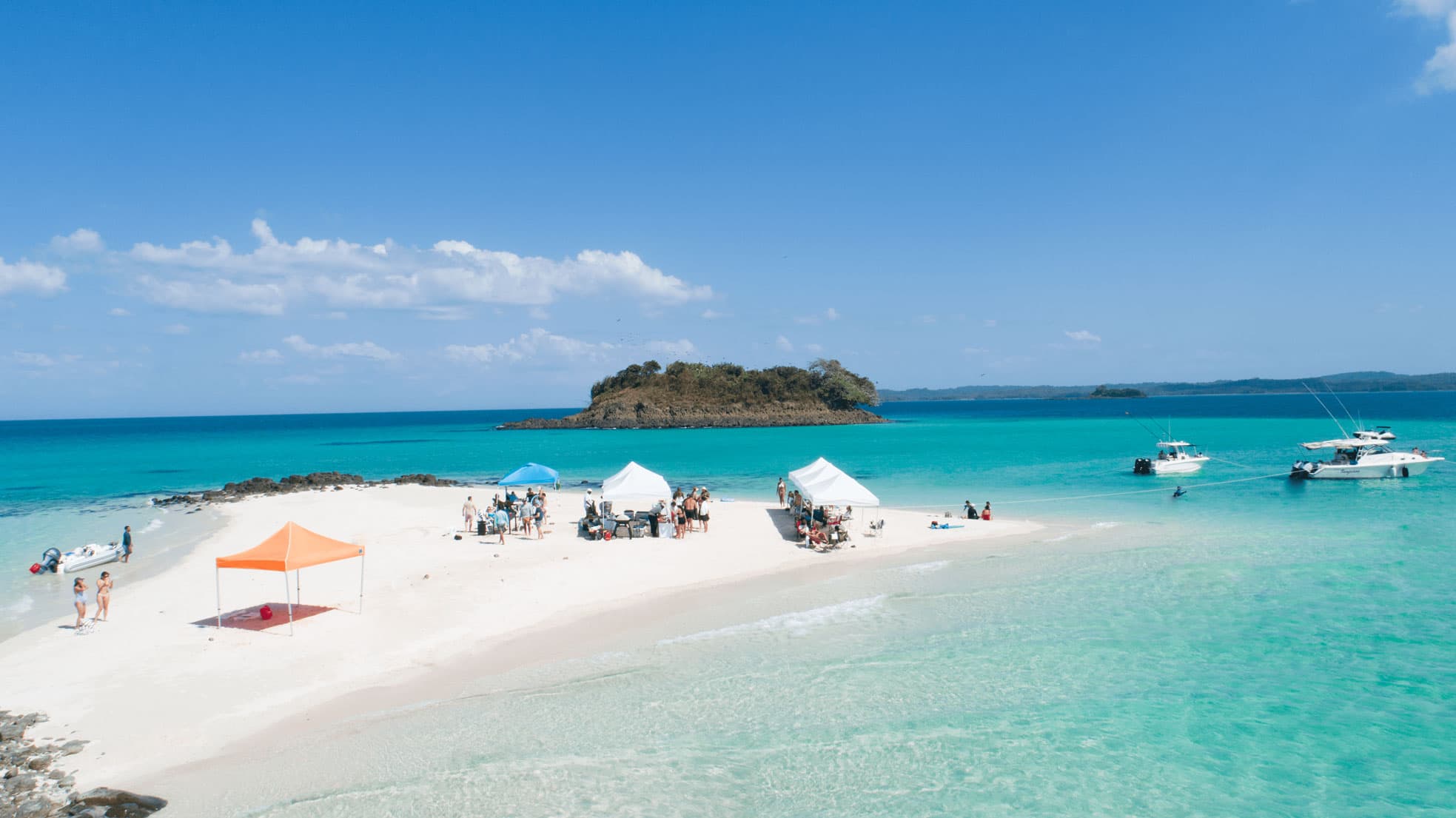 Sandbar beach with boats and turquoise water near Pearl Island
