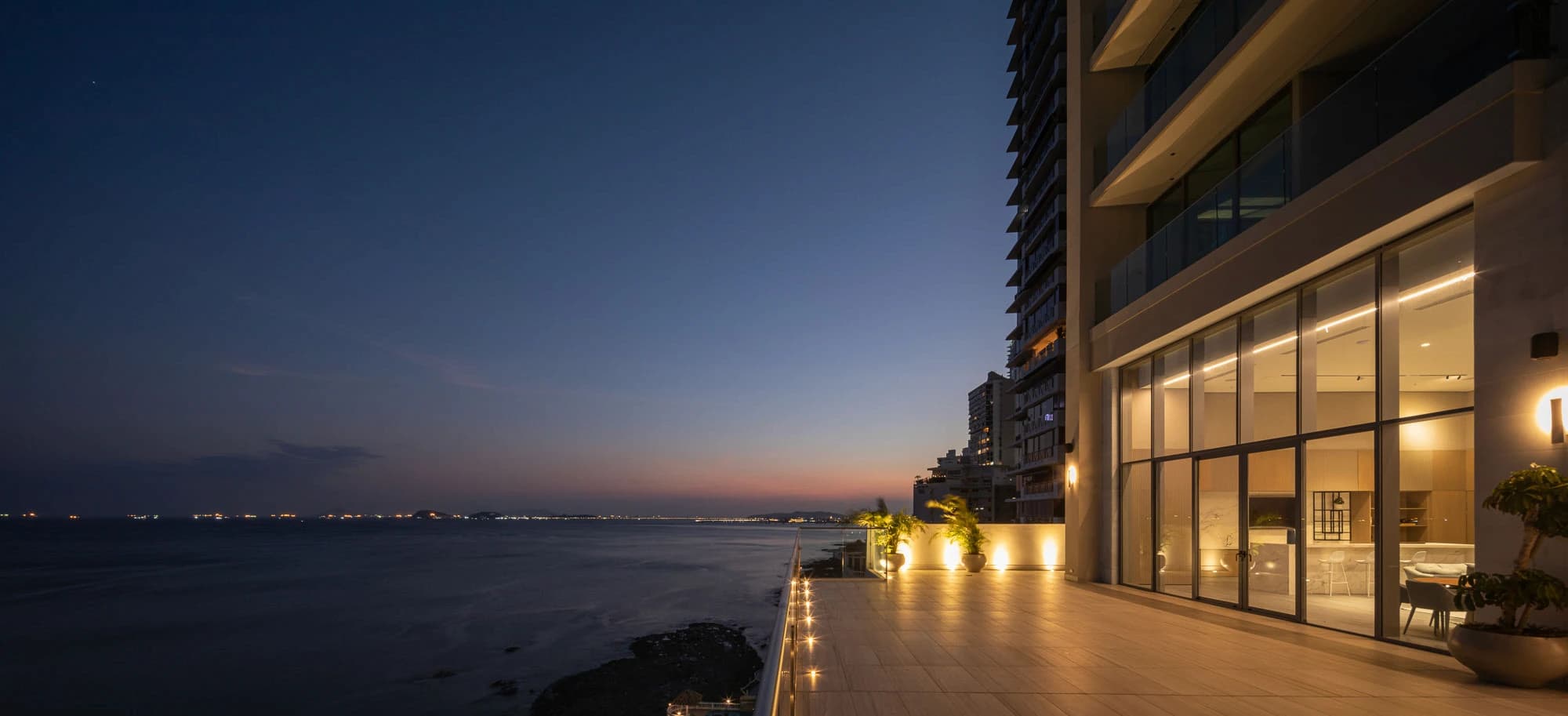 Sea Point waterfront terrace and lounge lit at dusk over the Pacific