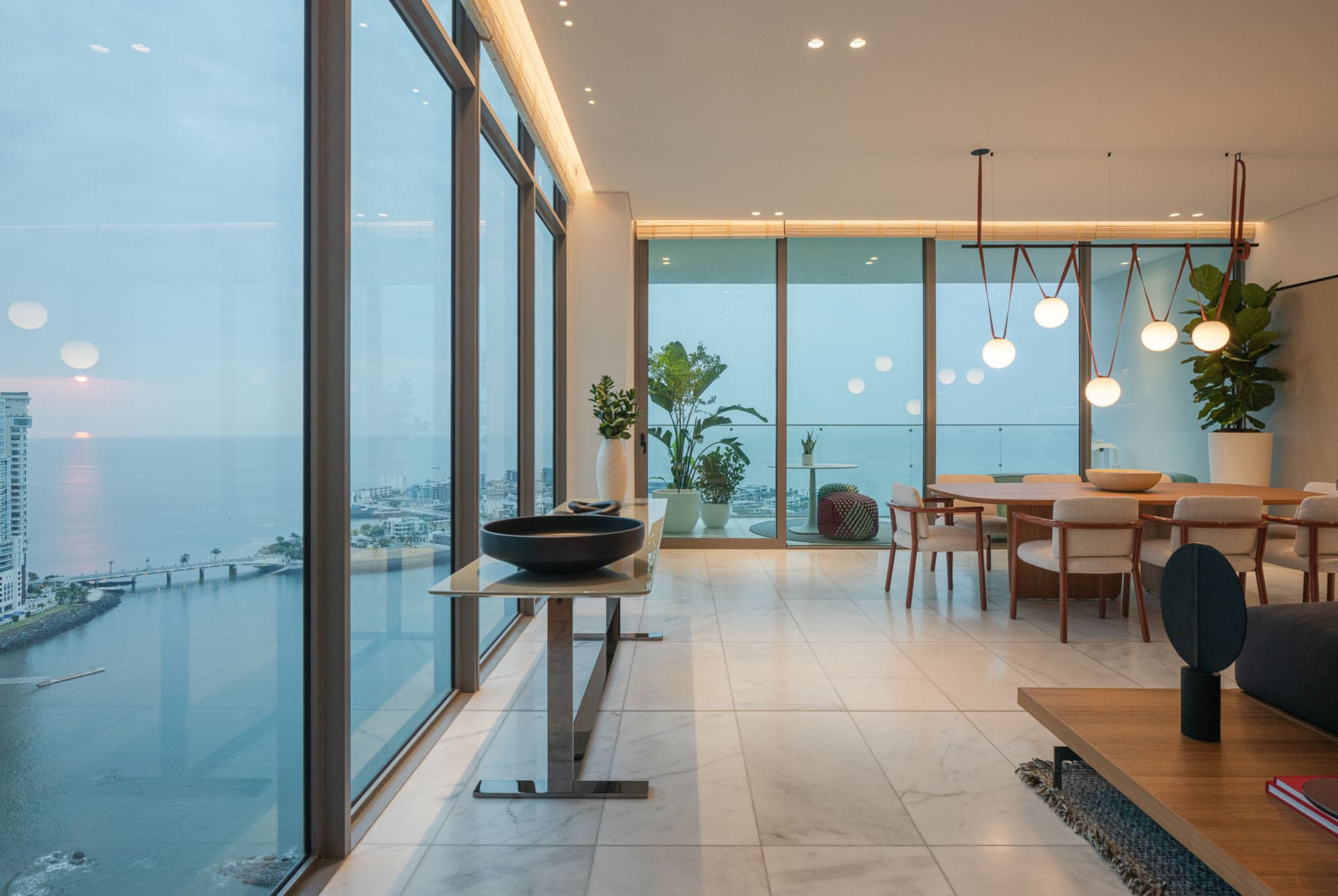Dining room with floor-to-ceiling windows over the bay in a Sea Point residence