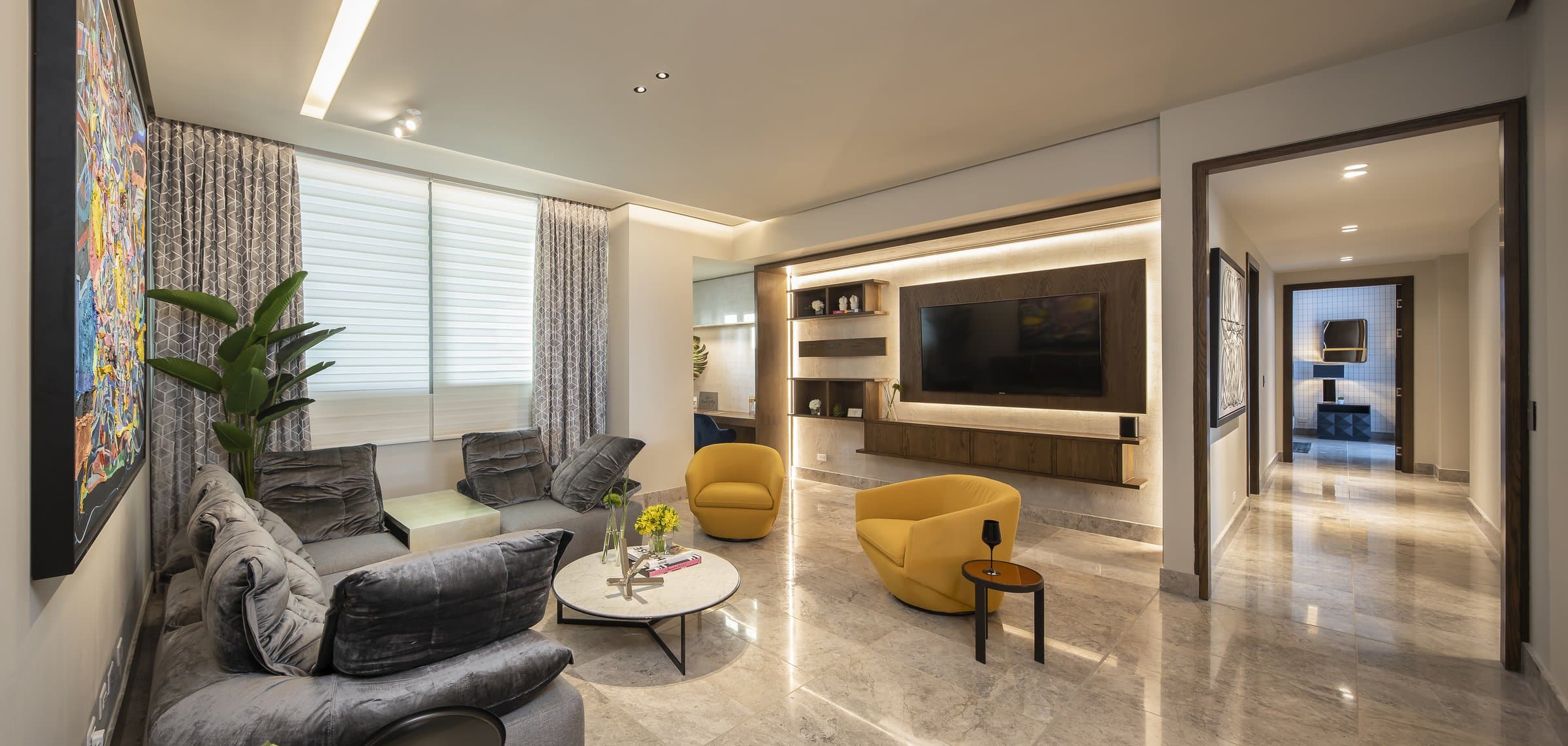 Living room with marble floors and built-in media wall in a Sea Point apartment
