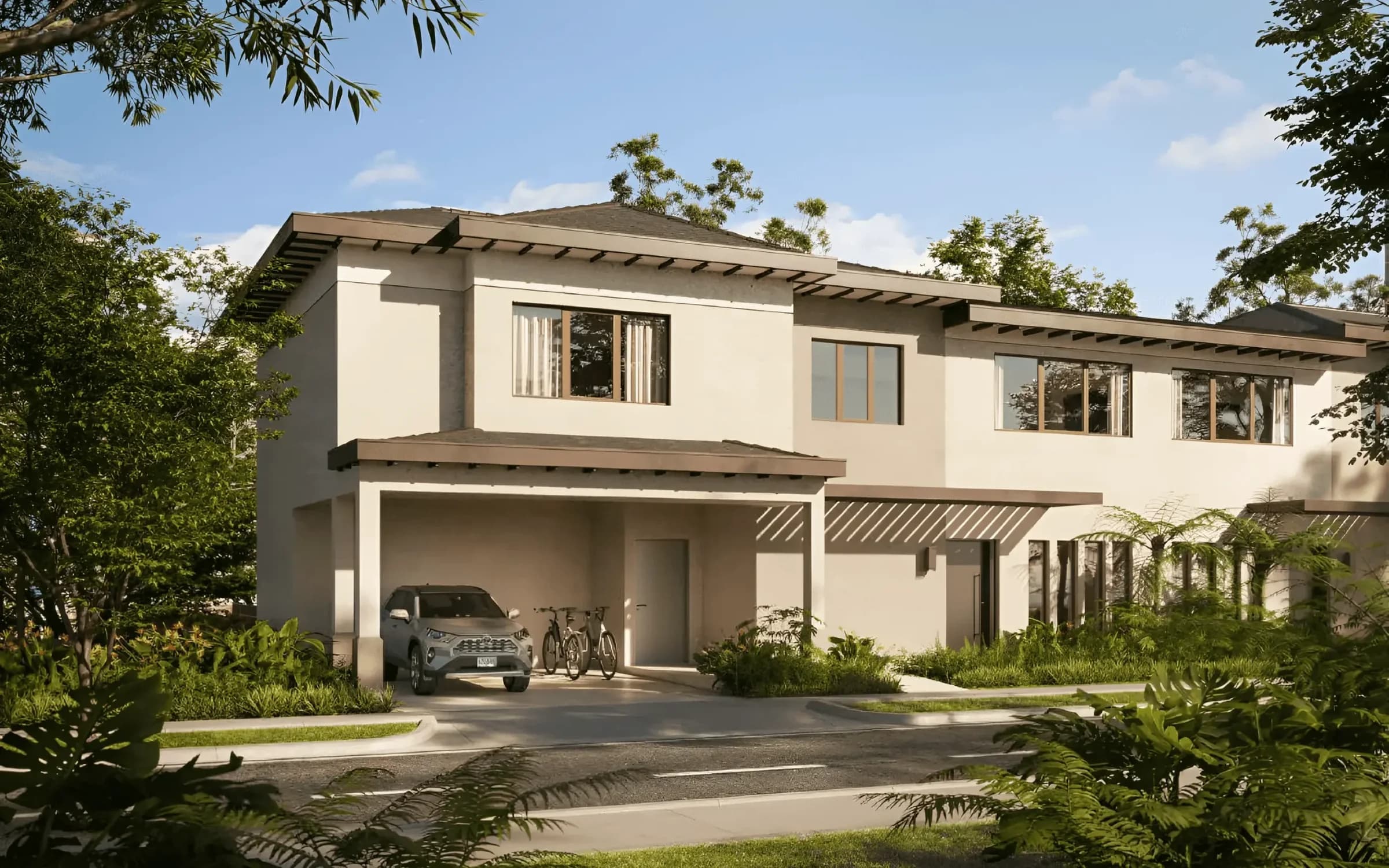 Two-storey duplex houses of The Woods among tropical landscaping in Santa Maria
