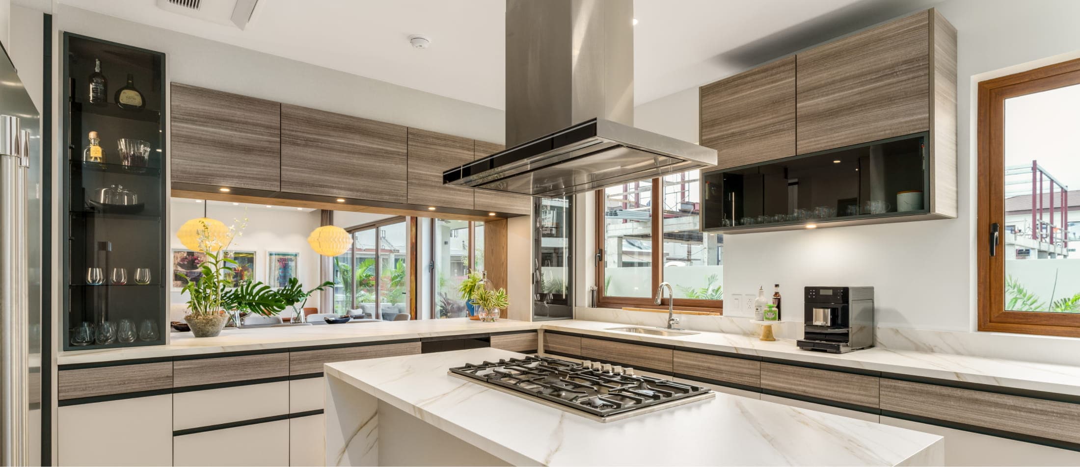 Kitchen with stainless range hood and wood cabinetry at The Woods