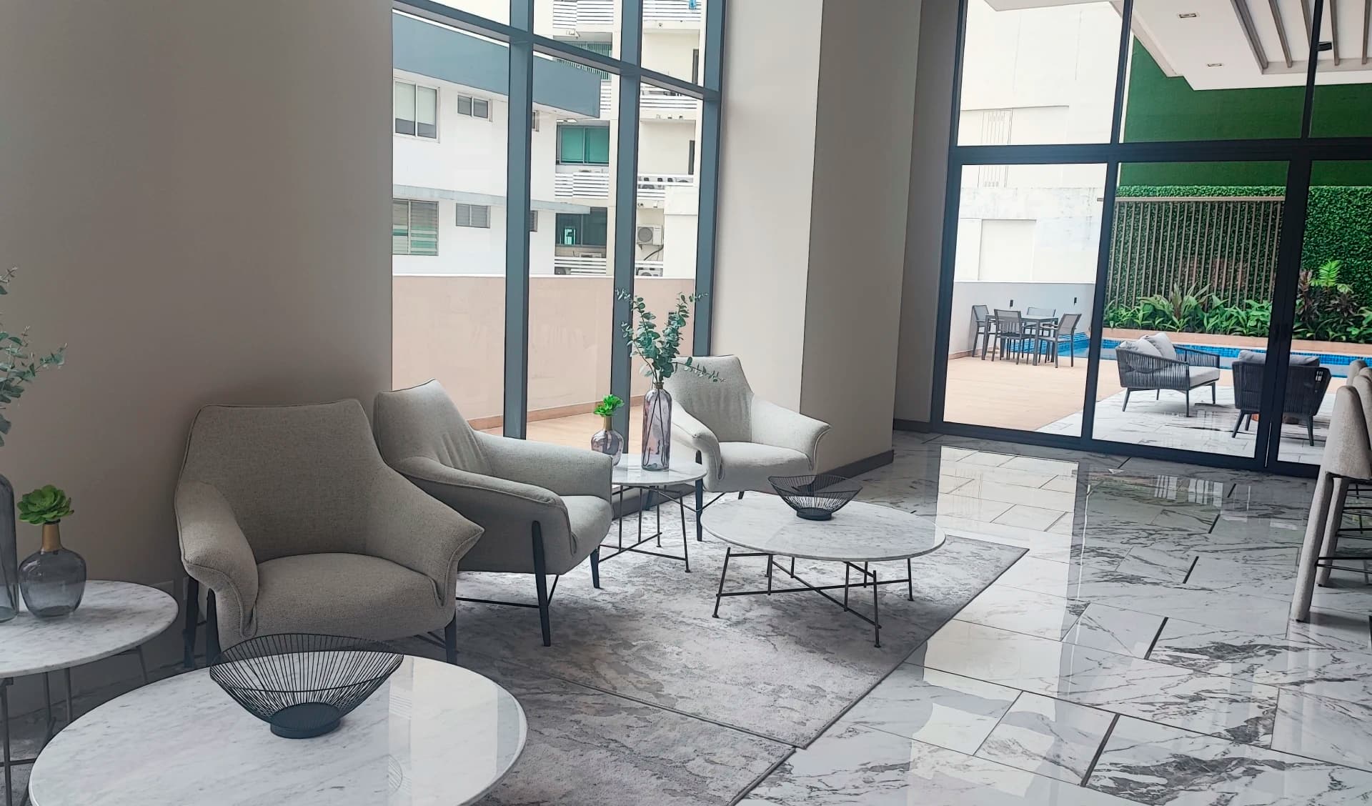 Lounge and co-working area opening onto the pool deck at Prestige Bella Vista