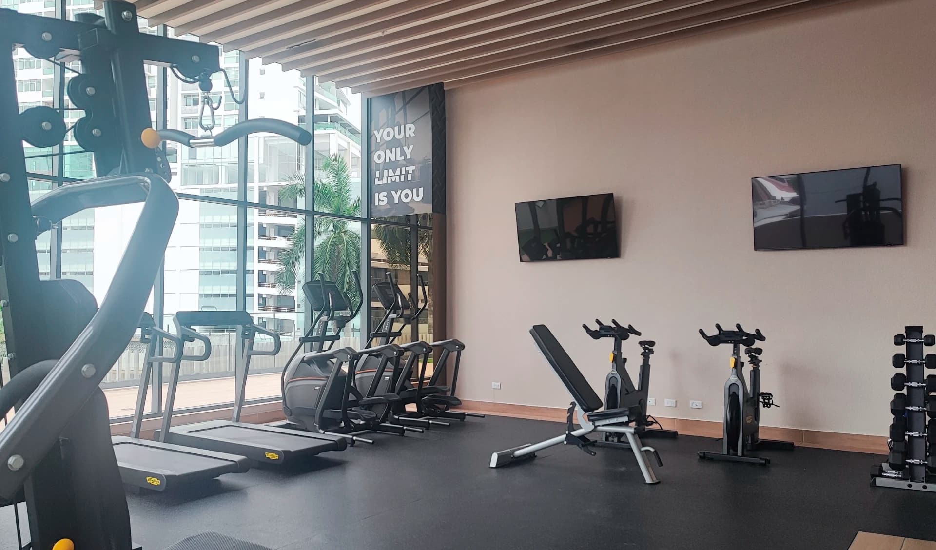 Fitness center with cardio machines and weights at Prestige Bella Vista