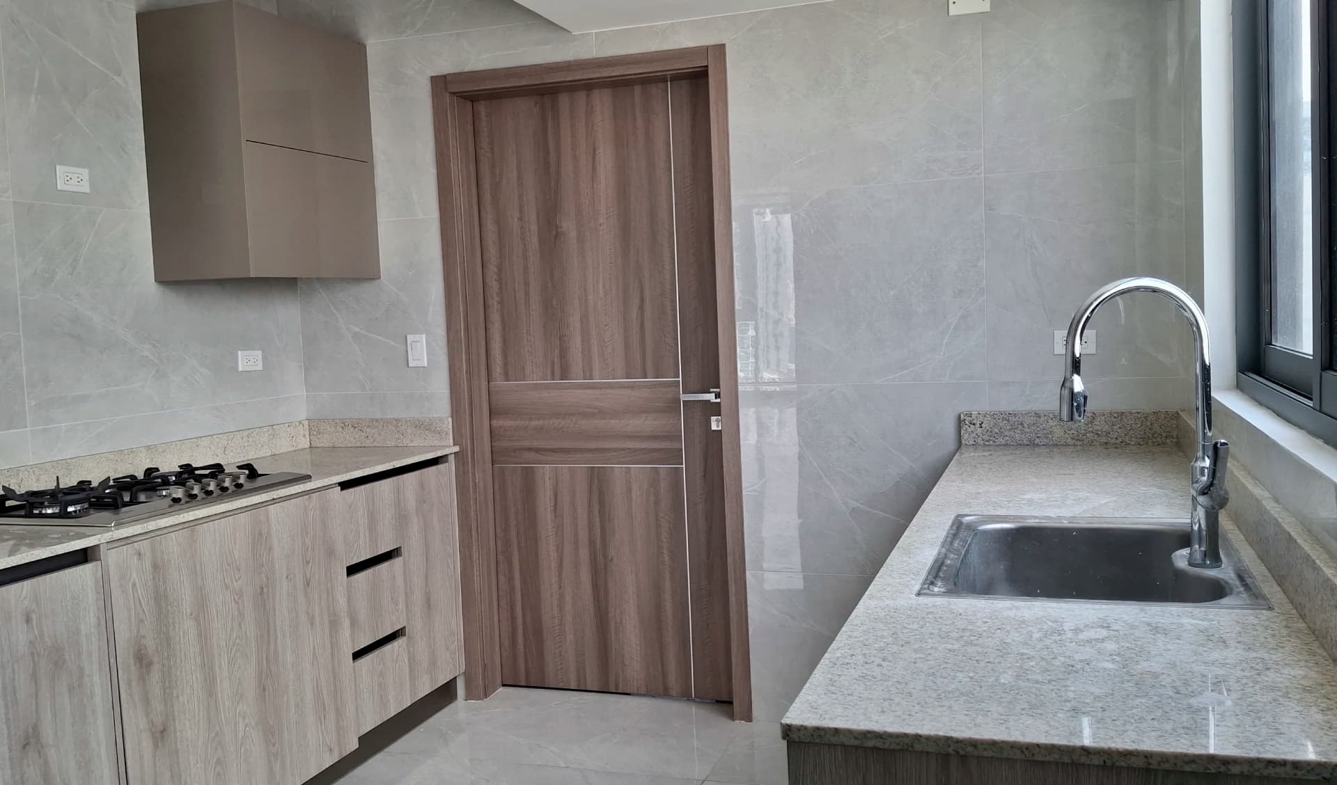 Kitchen with stone countertops in a Prestige Bella Vista apartment