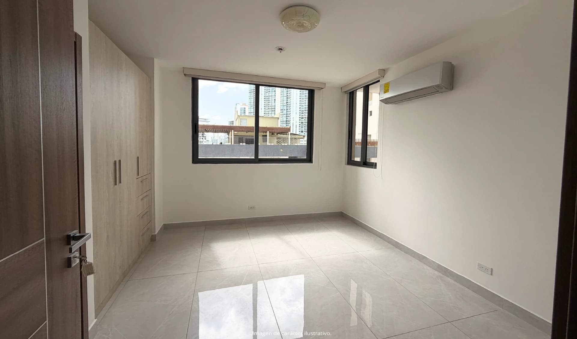 Bedroom with built-in closets and city view in a Prestige Bella Vista apartment