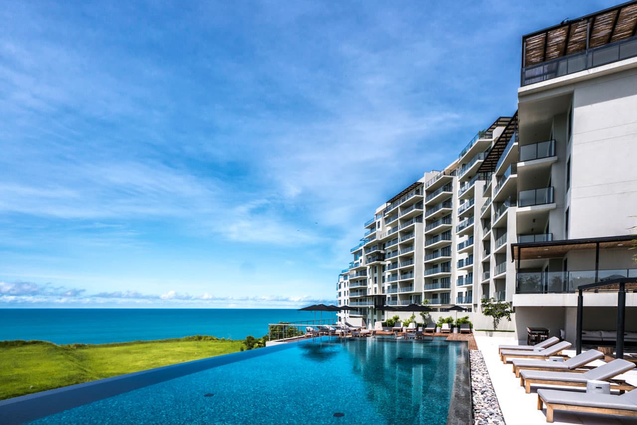 Solaria tower beside its oceanfront infinity pool at Punta Caelo