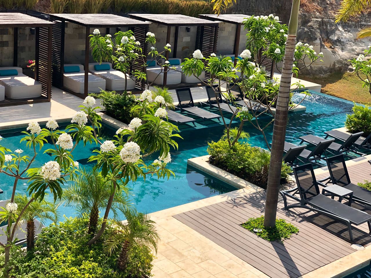 Tropical pool with cabanas and sun loungers at Solaria, Punta Caelo