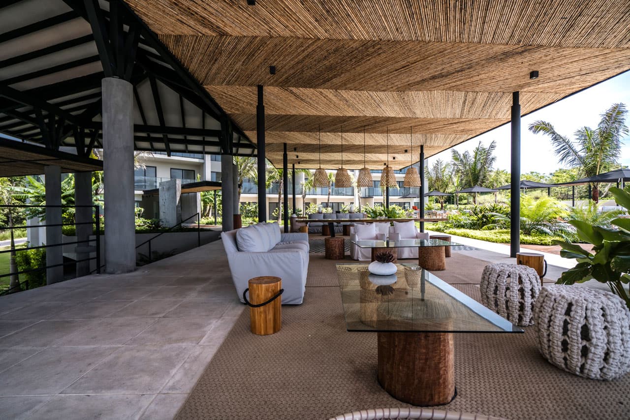 Social lounge with sofas under a woven ceiling at Solaria
