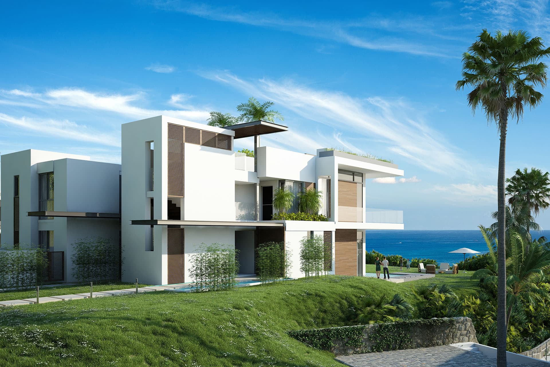 Modern white Caelo houses on the green bluff above the ocean