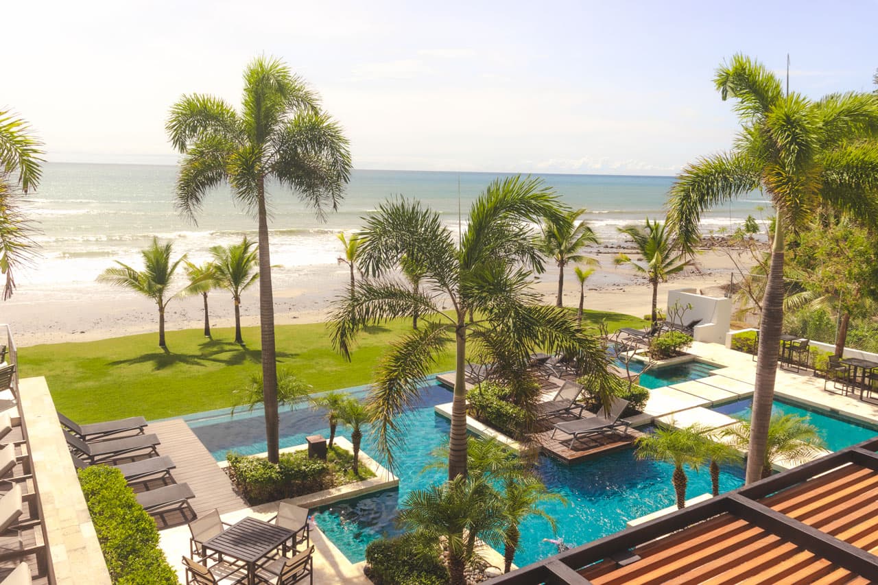 Beachfront pools and palm gardens at Punta Caelo