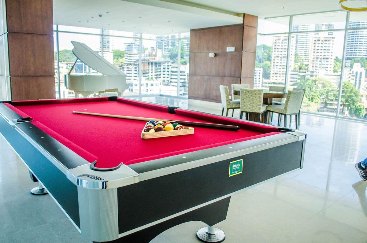 Game room with billiards table and grand piano at The Palace