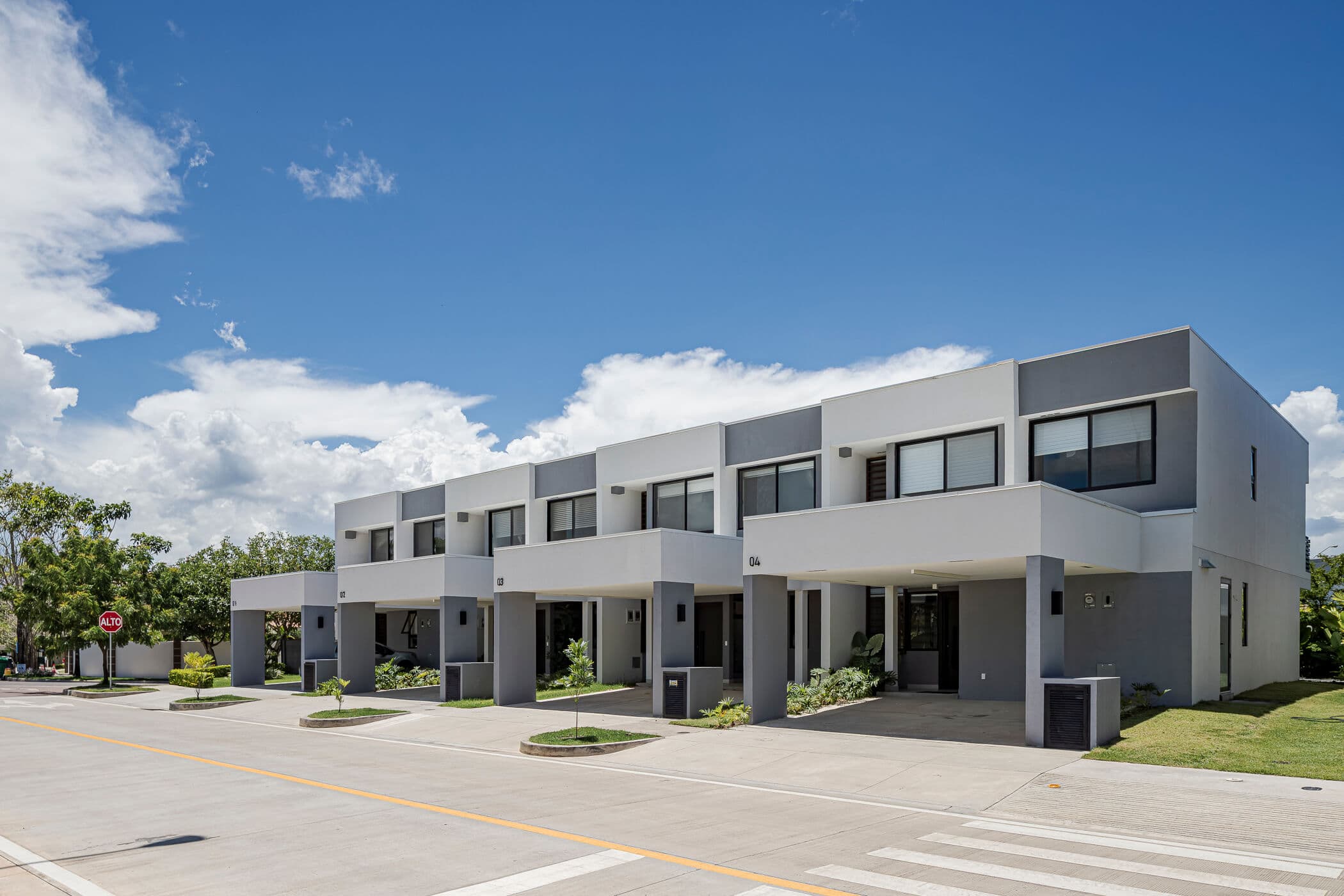 Row of two-story Imaterra townhomes along a community street