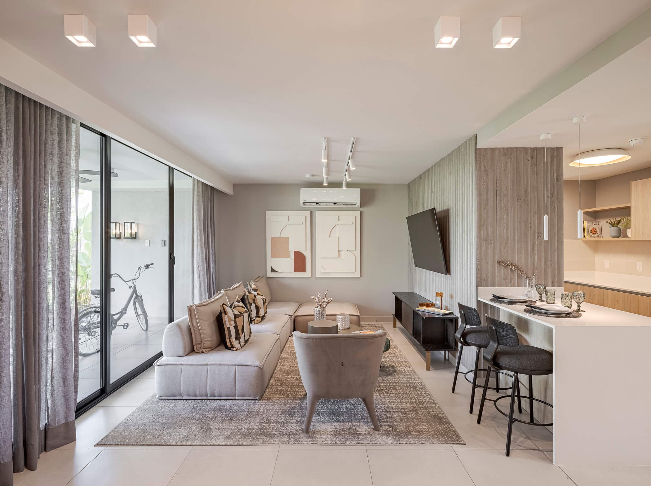 Open living room with kitchen bar in an Imaterra model home