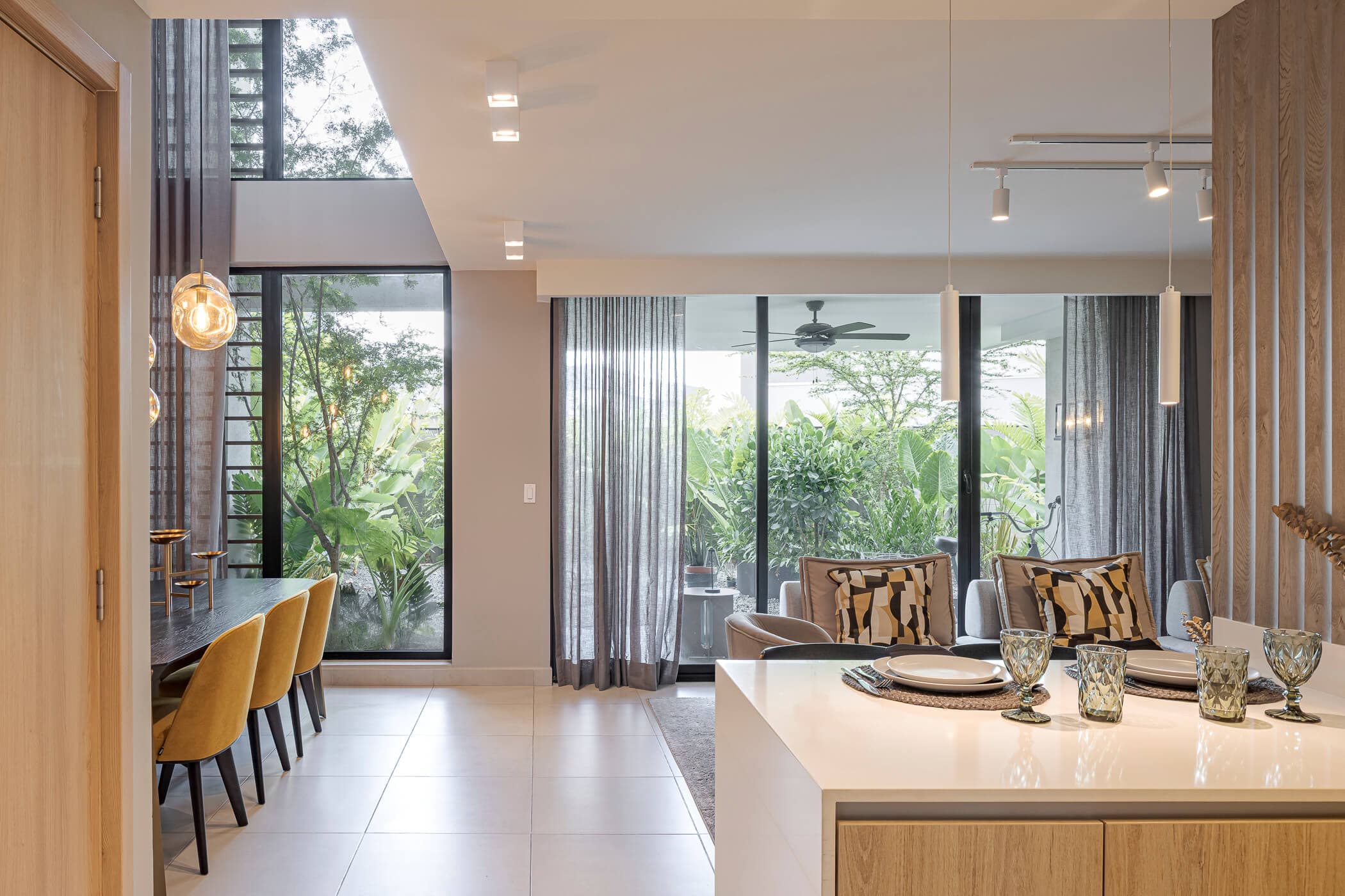 Kitchen island and dining area opening to the garden at Imaterra