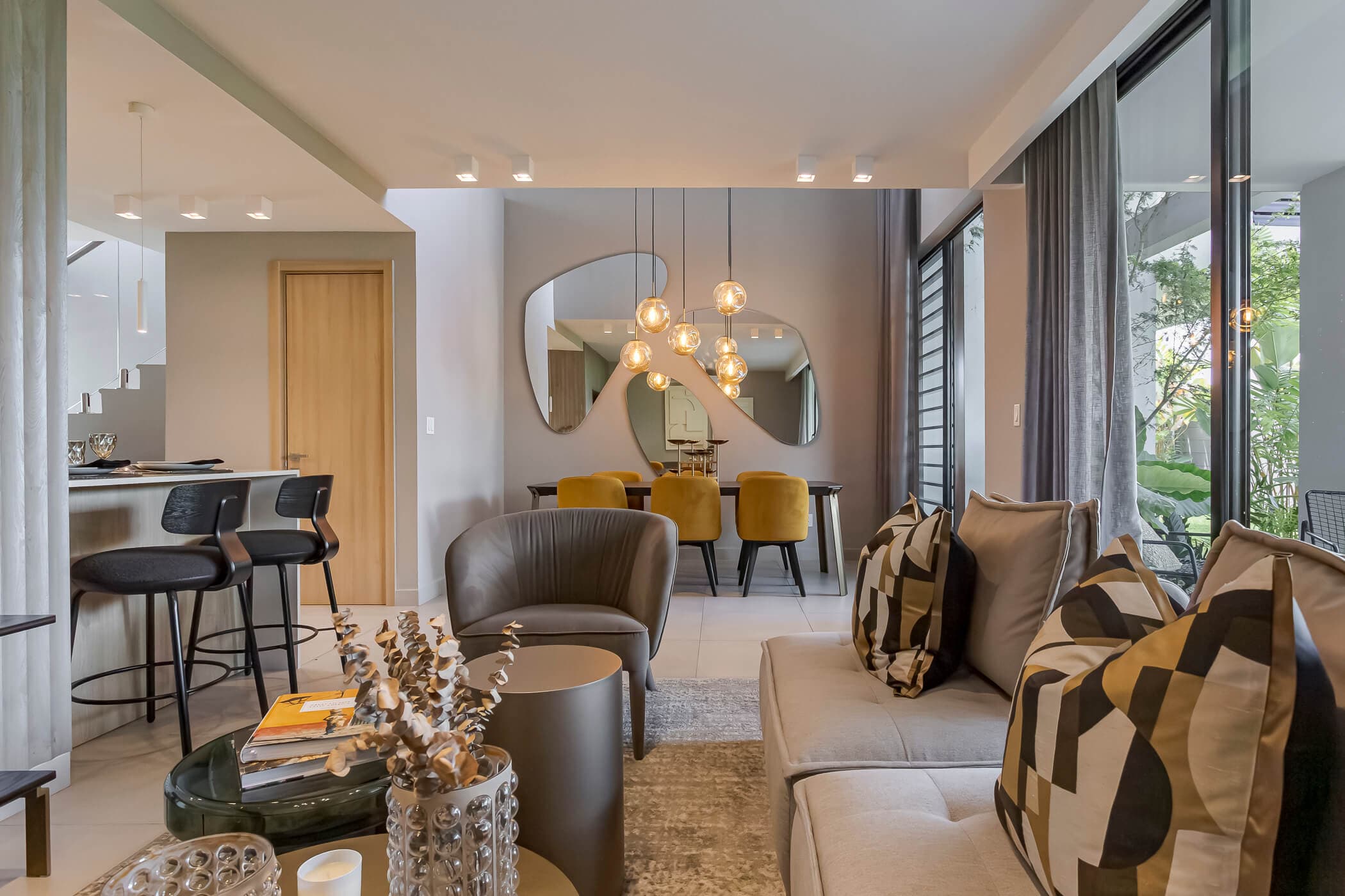 Living and dining area with pendant lights in an Imaterra home