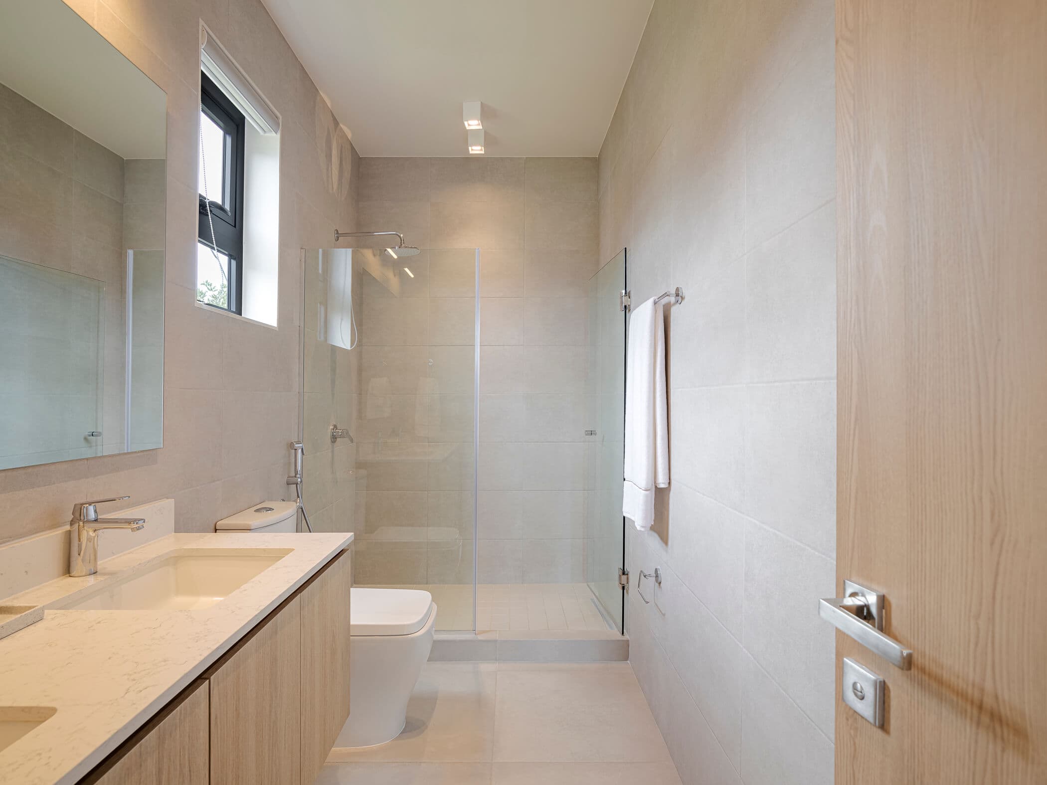 Bathroom with walk-in glass shower in an Imaterra home