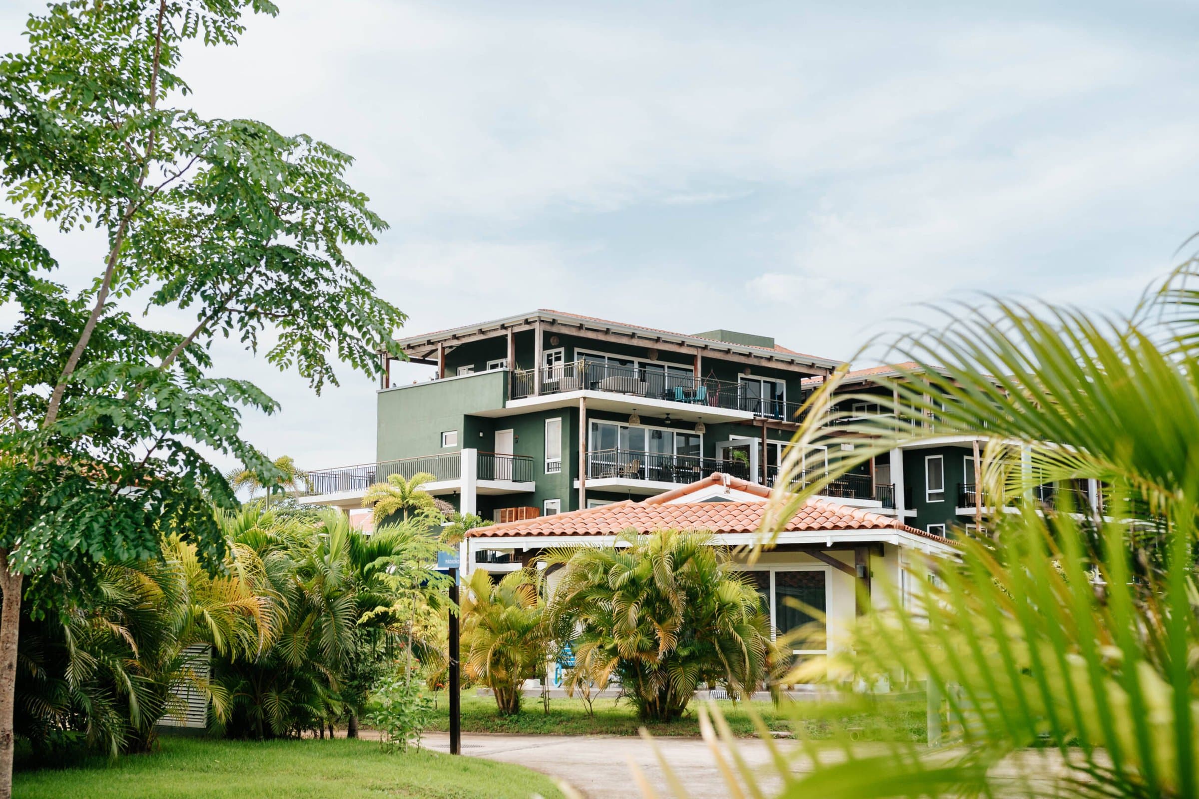Blue Venao condominium building framed by tropical palms in Playa Venao