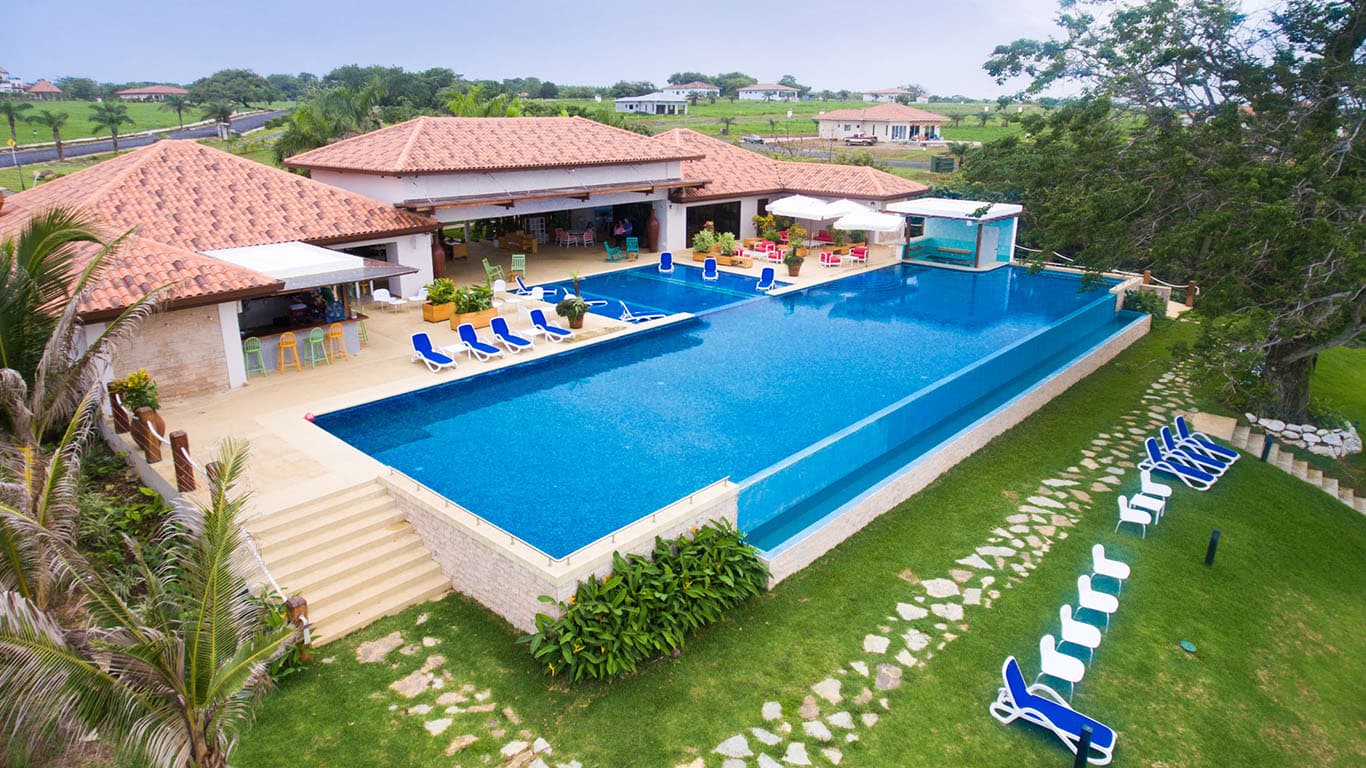 Aerial view of the Andromeda Beach Club infinity pool and clubhouse
