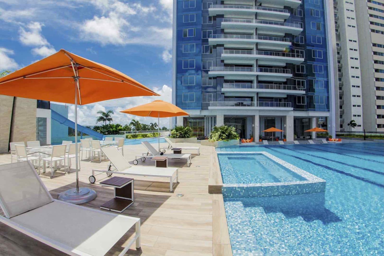Adult swimming pool with orange sun umbrellas on the Regalia social deck
