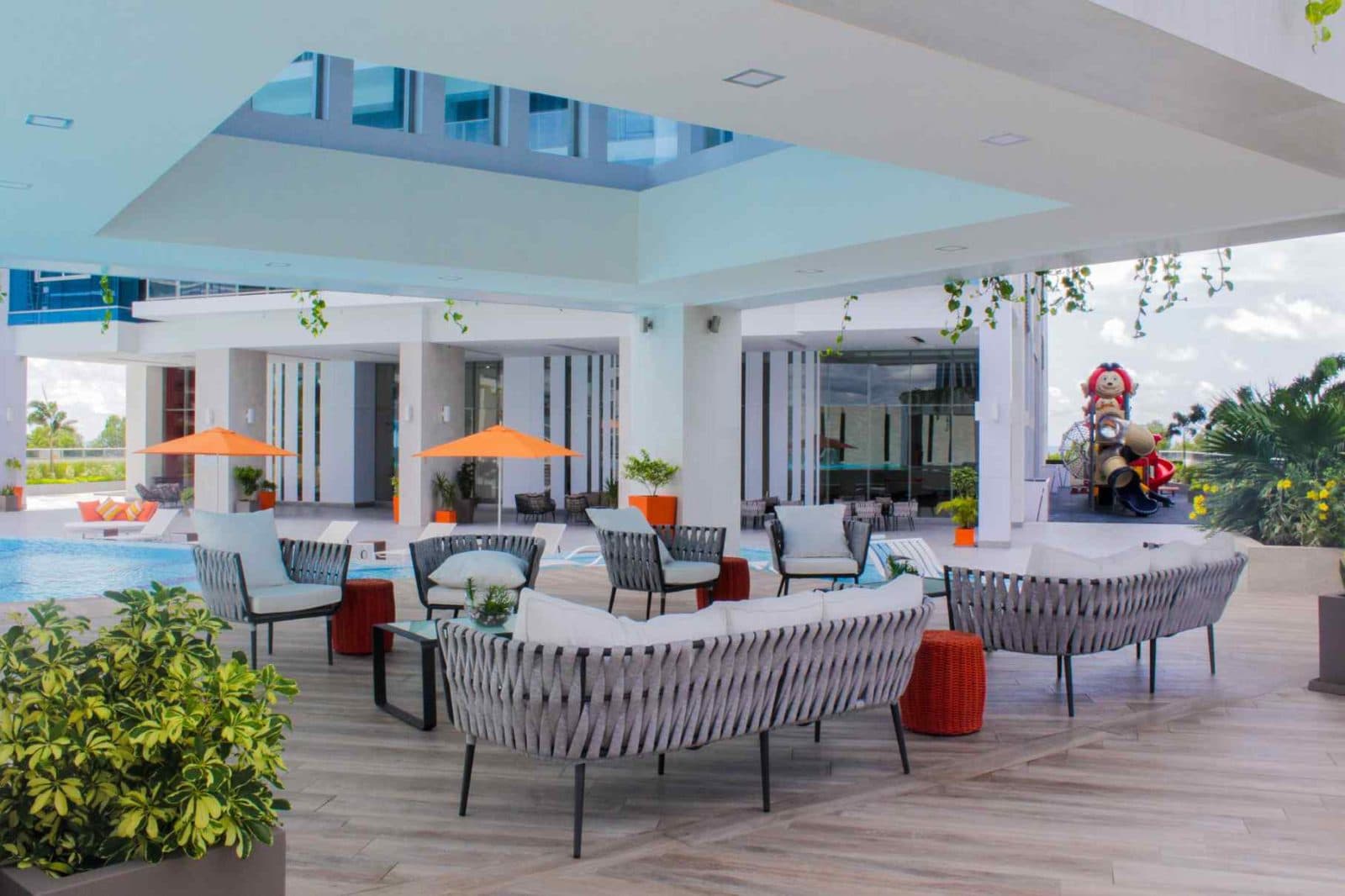 Covered lounge terrace overlooking the pool area at Regalia