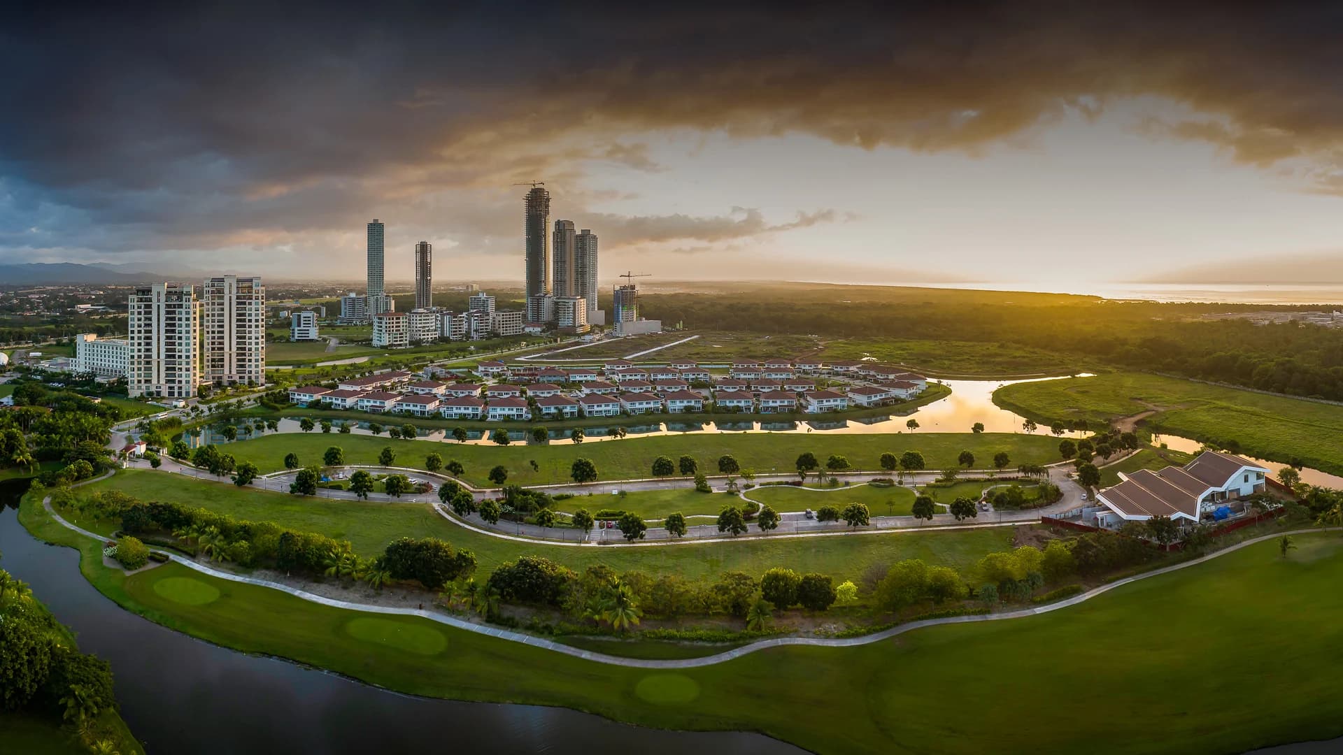 Sunset aerial view of Santa Maria's golf course, lakes and residential towers
