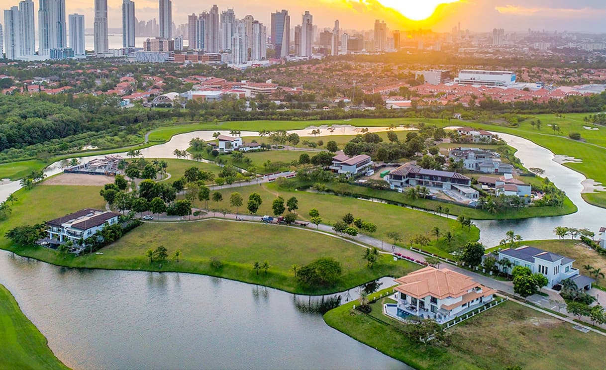 Aerial view of lakeside estates at Santa Maria Golf & Country Club at sunset