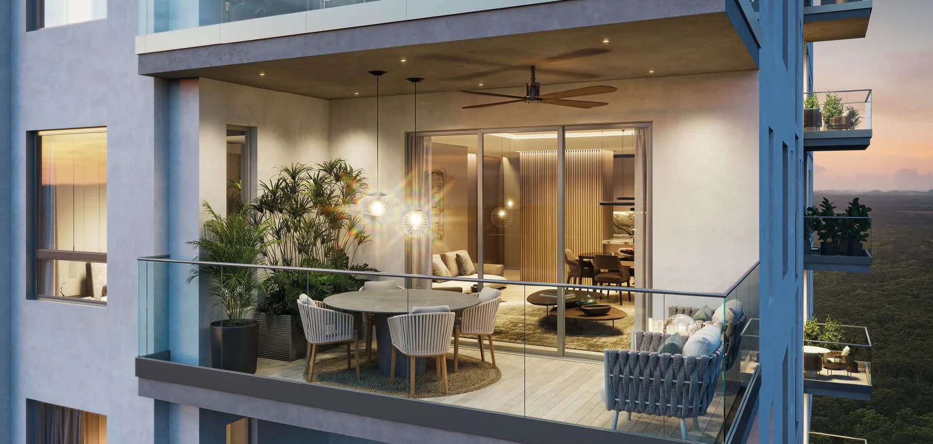 Balcony of a Santa Maria apartment with living and dining room at dusk