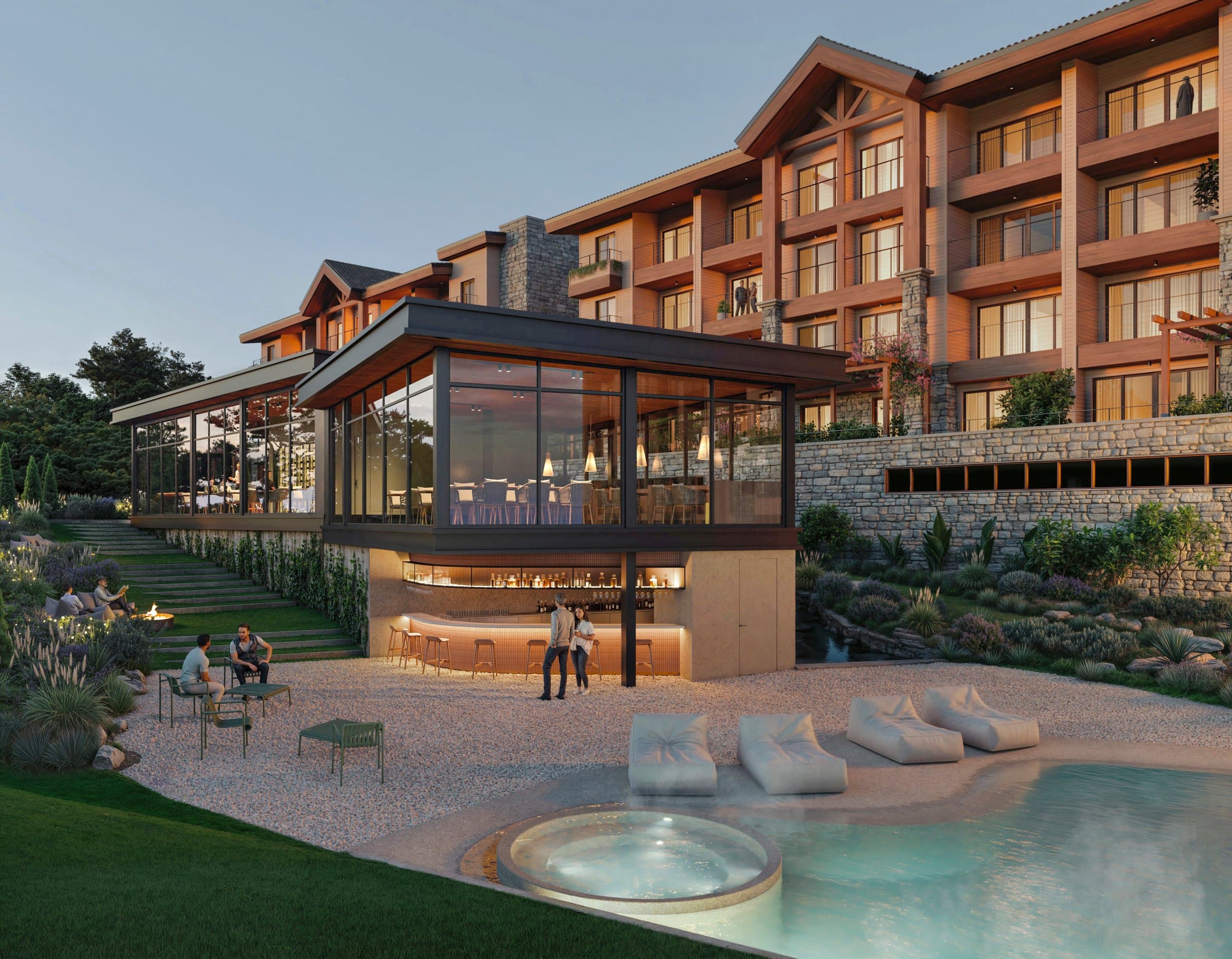Pool with jacuzzi and glass-walled bar pavilion at Pinoalto, with the buildings behind