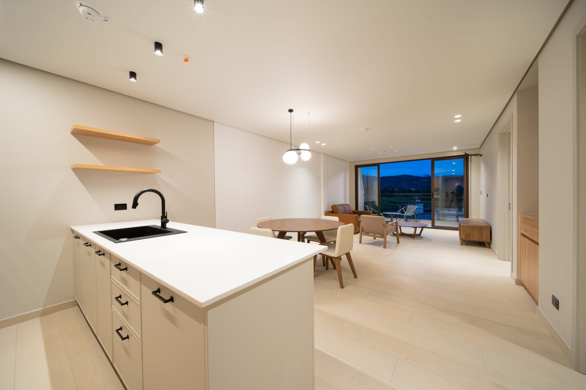 Kitchen island and dining area in a delivered Pinoalto condo-suite