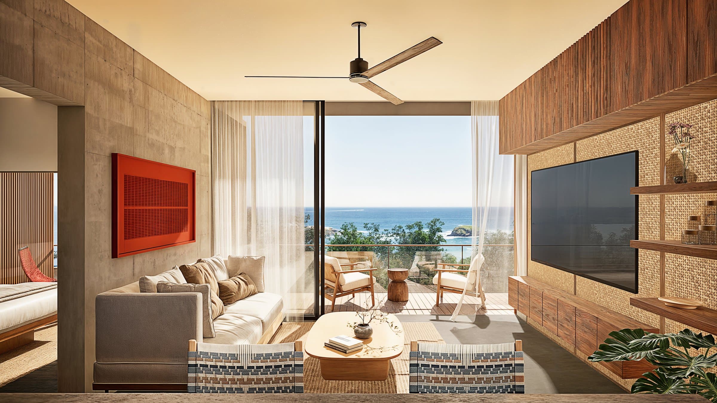 Living room with ceiling fan and ocean view inside a Vervana condo