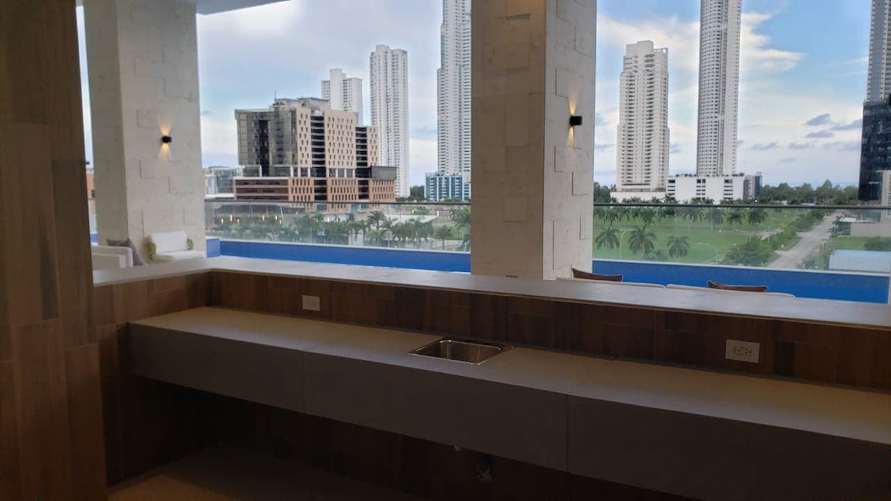 Open bar counter overlooking the pool and Costa del Este at Parkview Residence