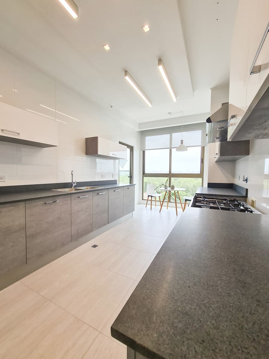 Galley kitchen with modern cabinetry in a Parkview Residence apartment