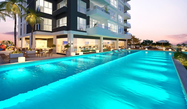 Rendering of the Greengarden lap pool lit at dusk beside the tower