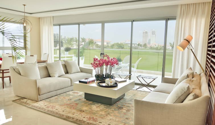 Living room with golf course view in a Greengarden apartment in Santa Maria