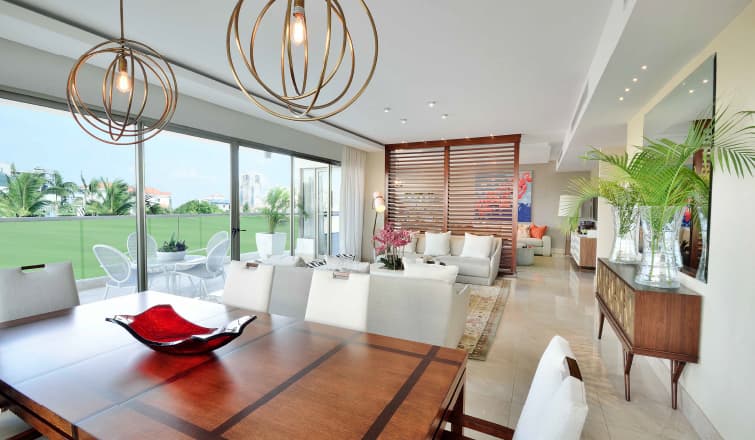 Dining room with pendant lights and garden view in a Greengarden apartment
