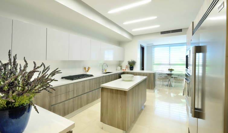 Kitchen with island and white cabinetry in a Greengarden apartment