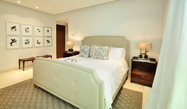Main bedroom with upholstered bed in a Greengarden apartment