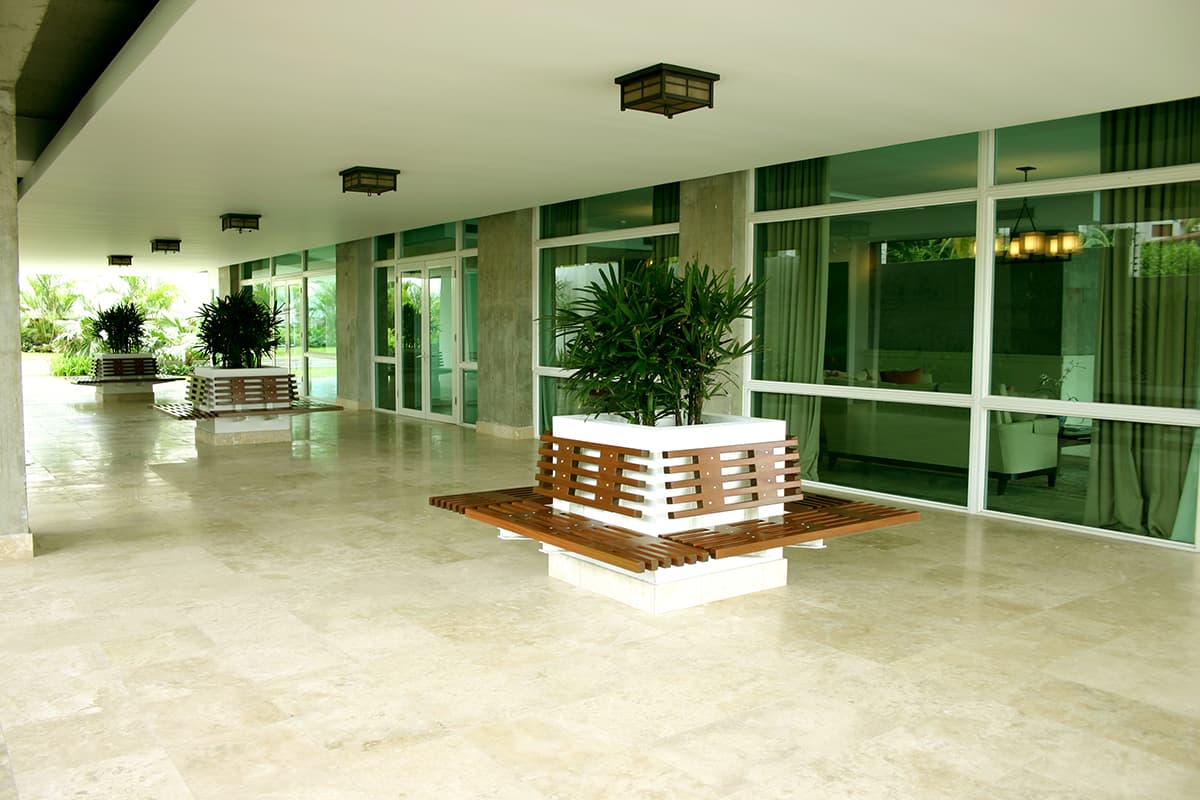 Covered lobby terrace with planters at PH Pradera